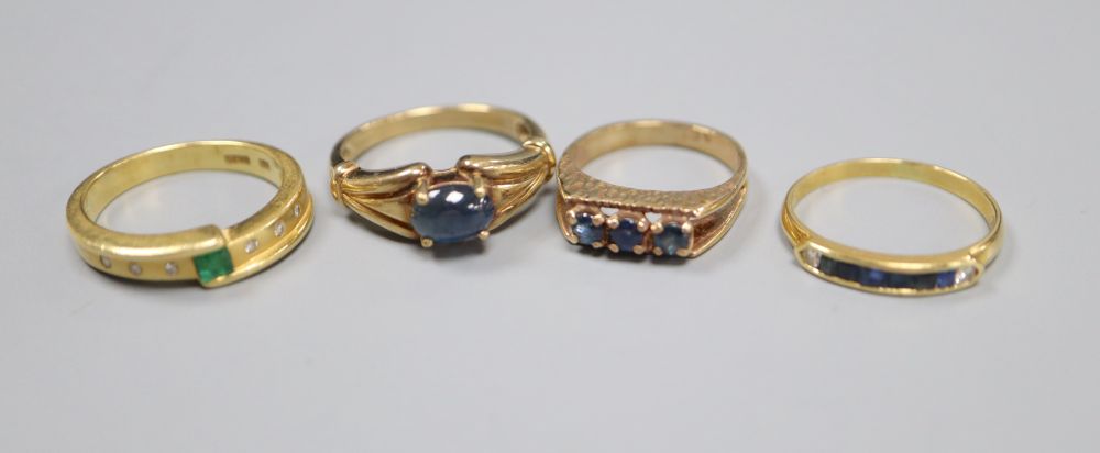 An 18ct gold, emerald and diamond asymmetric ring, an 18ct channel-set sapphire and diamond half-eternity ring and two 9ct rings